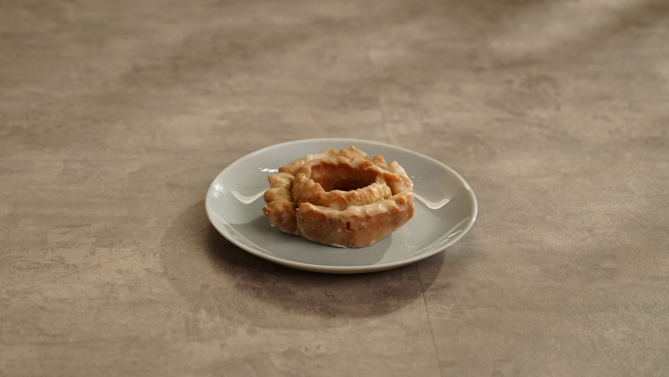 Lifestyle shot of GLAZED PUMPKIN OLD FASHIONED DONUT 3.7 OZ